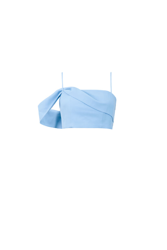 Product shot of asymmetric off shoulder crepe crop top in pastel blue color and iridescent sequins mini skirt